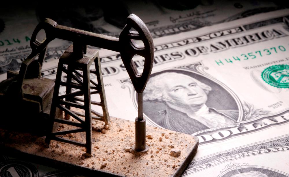 A 3D-printed oil pump jack is placed on dollar banknotes in this illustration picture, – Reuterspix