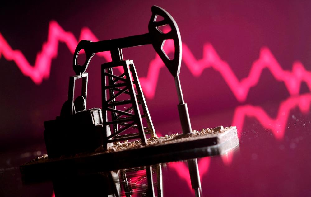 A 3D printed oil pump jack is seen in front of displayed stock graph in this illustration picture. – Reuterspic