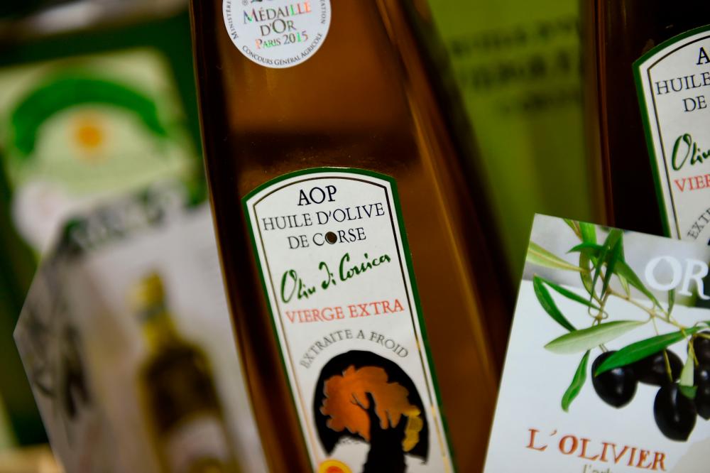 A bottle of Corsica's AOP or PDO (Protected Designation of Origin) olive oil. A USTR document listed products from France, Germany, Spain or Britain, ranging from olives to decaffeinated coffee, as possibly subject to new tariffs. – AFPPIX