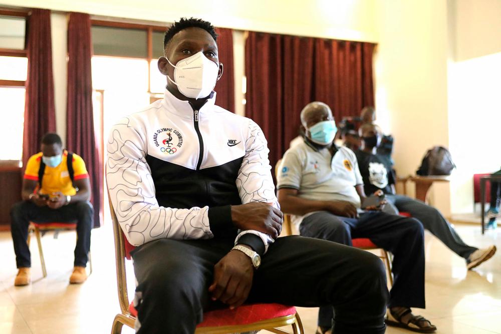 The Uganda National boxing team Captain Sadir Bwoji listening to Denis Obua, Ugandan Minister of State for Sports, during a speech at the National council of sports headquarters in Kampala, Uganda, on June 17, 2021 ahead of their departure to participate in the Tokyo Olympic games. – AFPPIX