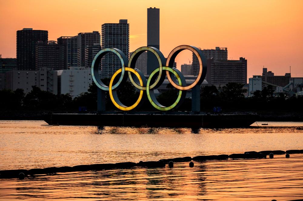 The Olympic rings are lit at the waterfront of Odaiba in Tokyo on April 20, 2021. –AFP