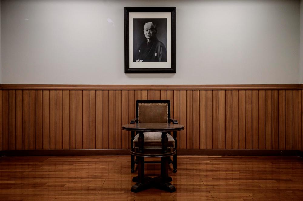 $!In this picture taken on February 19, 2020, a portrait of Jigoro Kano, the founder of judo, is seen above his chair and desk at the Kodokan, judo’s headquarters, in Tokyo. / AFP / Yasuyoshi CHIBA