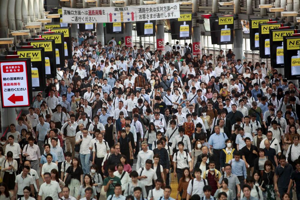 In this picture taken on July 18, 2019 people commute during a morning rush hour at Shinagawa station in Tokyo. — AFP