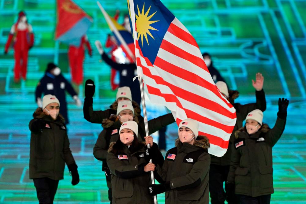 Malaysia’s flag bearers Aruwin Salehhuddin and Jeffrey Webb lead the delegation during the opening ceremony of the Beijing 2022 Winter Olympic Games, at the National Stadium, known as the Bird’s Nest, in Beijing, on February 4, 2022. AFPPIX