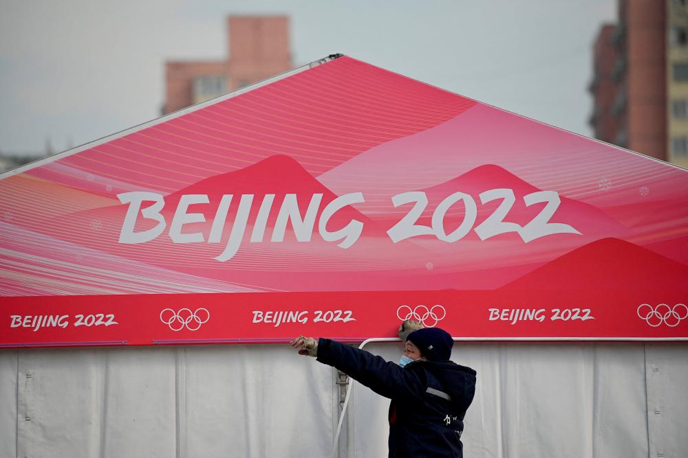 A worker is seen at the entrance of the Wukesong Sports Centre, venue for the ice hockey competition during the 2022 Beijing Winter Olympics, in Beijing on January 18, 2022. AFPPIX