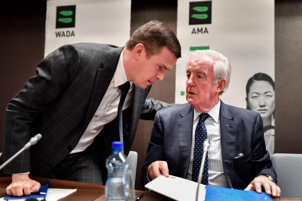 World Anti-Doping Agency (Wada) President-Elect Witold Banka (L) speaks with Wada President Craig Reedie during a press conference following a meeting of the Wada executive committee on Russian ban on December 9, 2019 in Lausanne. - AFP
