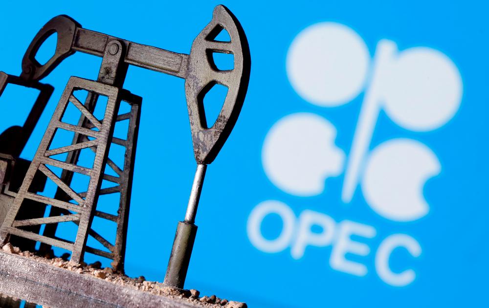A 3D-printed oil pump jack is seen in front of displayed Opec logo in this illustration picture – REUTERSPIX