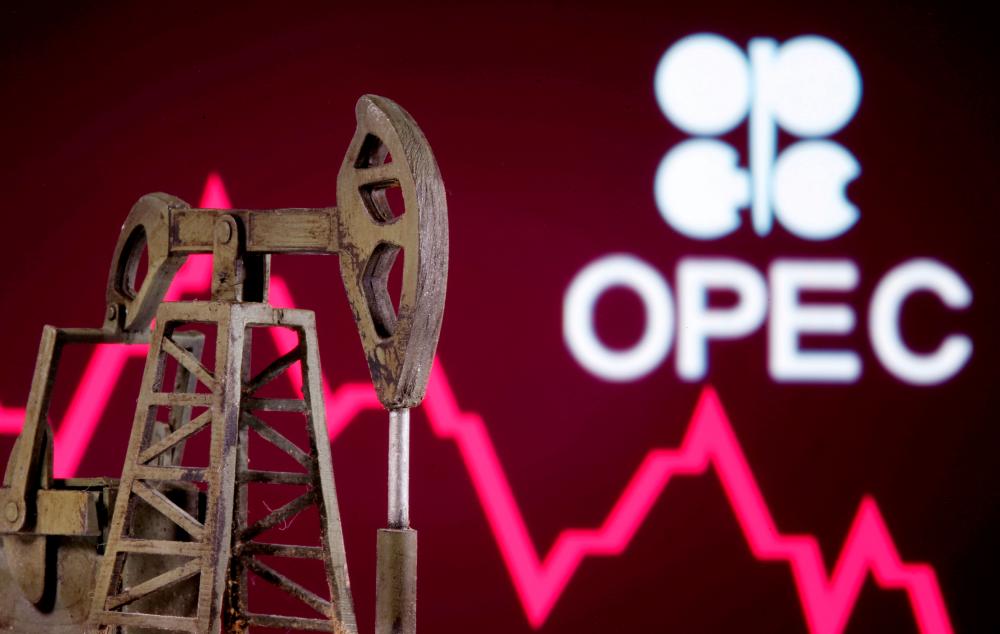 A 3D printed oil pump jack is seen in front of displayed stock graph and Opec logo in this illustration picture. – REUTERSPIX