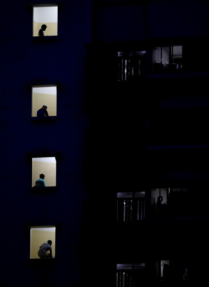 Migrant workers pray in their dormitory during the holy month of Ramadan, amid the coronavirus disease (Covid-19) outbreak in Singapore May 10, 2020. - Reuters