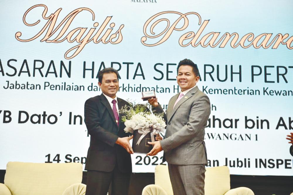 Finance Ministry director-general of valuation and property services department Abdul Razak Yusak (left) and Indera at the launching ceremony.