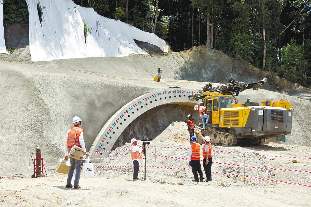 Work being carried out on an ECRL tunnel at Bukit Bauk in Dungun district, Terengganu, on March 27 last year. An estimated 44 tunnels will serve the 688km railway line. – Bernamapix