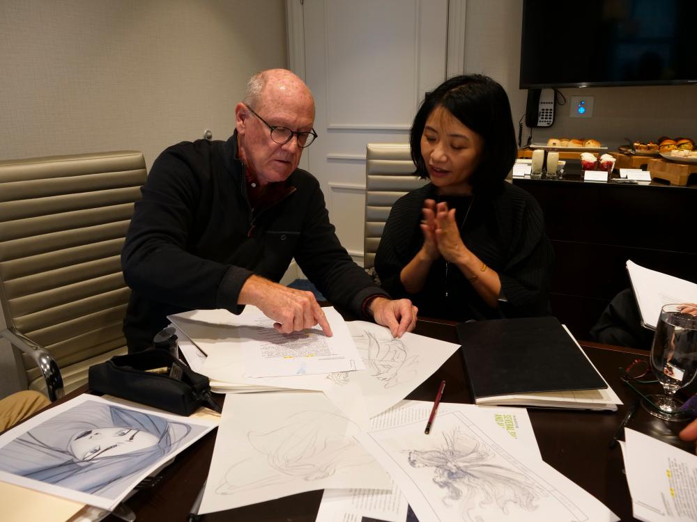 $!Glen Keane and Guo Pei going over the sketches and looks