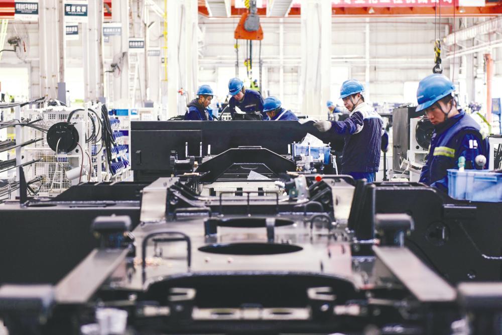 A crane production line at a factory in Zhangjiakou in China’s northern Hebei province. Global manufacturing PMI for December slowed amid marginal growth in output and continued decline in new export orders. – AFPPIX