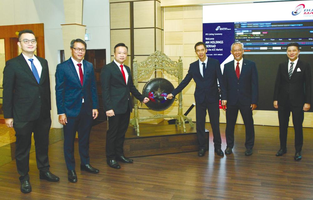 From left: M&amp;A Securities Sdn Bhd deputy head of corporate finance Danny Wong, MN Holdings executive directors Dang Siong Diang and Datuk Clement Toh, Loy, chairman Datuk Zainurin Karman and M&amp;A Securities managing director of corporate finance Datuk Bill Tan at the listing ceremony.