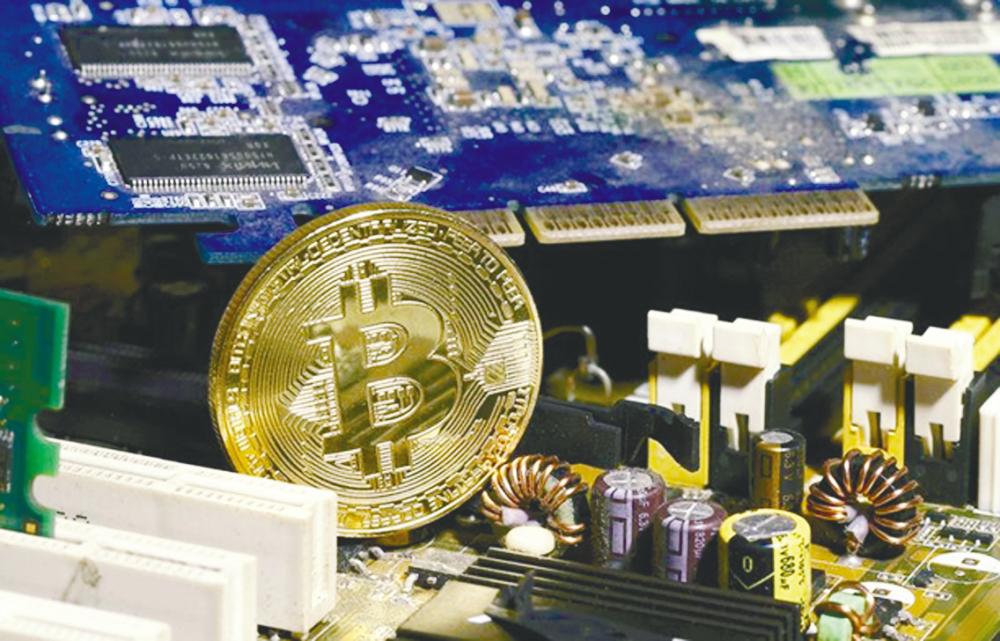 A copy of bitcoin, a type of digital asset, is shown standing on a PC motherboard. Existing digital asset operators in Malaysia have until Friday to identify themselves to the SC. - REUTERSPIX
