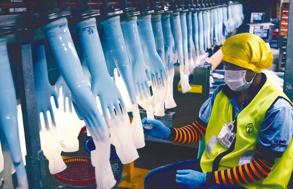 Production line at a Top Glove factory. Glove makers such as Top Glove, Supermax and Kossan are seen as potential beneficiaries amid a coronavirus outbreak in the region. – REUTERSPIX
