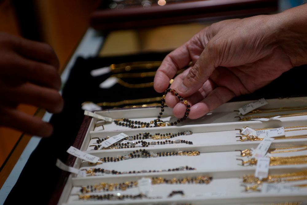 A customer selects gold jewellery at a store in Mumbai. The World Gold Council says India's gold consumption fell by 56% in the first half of 2020 compared with a year ago. – AFPPIX