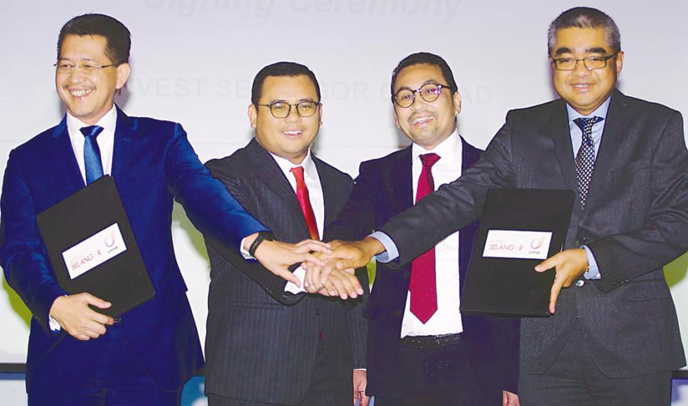 From left: Invest Selangor CEO Datuk Hasan Azhari Idris, Amirudin Shari, UMW Holdings manufacturing and engineering division president Datuk Abdul Rashid Musa and Wafi Nazrin at the signing ceremony today. ZULKIFLI ERSAL/theSun