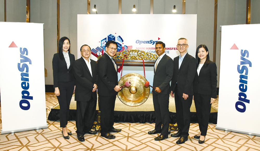 From left: OpenSys group CFO Winnie Ong, chief compliance officer Chee Hong Soon, Lim, OpenSys Technologies CEO Luke Sebastian, business process outsourcing senior vice president Koh Lea Cheong, and software development &amp; integration senior vice president Wong Siew Pooi at the listing transfer ceremony.