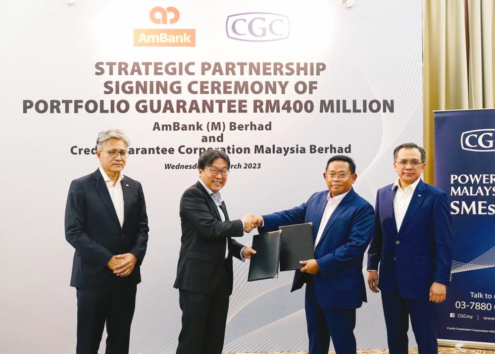 From left: Sulaiman, AmBank Bhd managing director (retail banking) Aaron Loo, CGC Malaysia Bhd senior vice-president (business development &amp; products) Mohamed Azman Mohamed Taufik and Mohd Zamree at the signing ceremony.