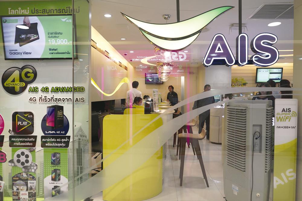 Customers waiting for service at an AIS shop in Bangkok. – REUTERSPIX