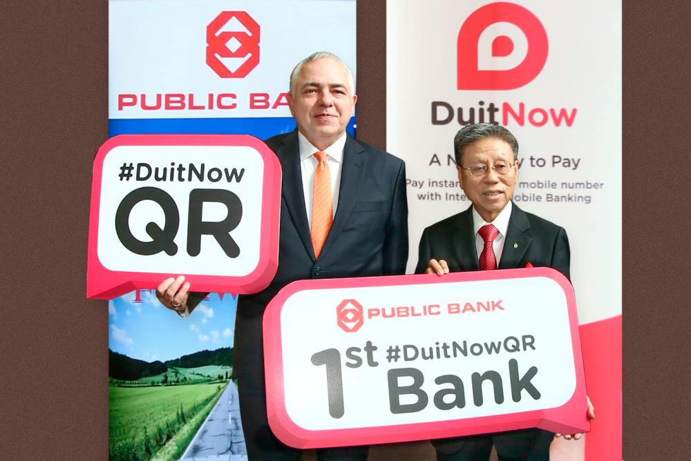 PayNet group CEO Peter Schiesser (left) and Tay during Public Bank’s soft launch of the Malaysia’s National QR Standard: DuitNow QR on July 17, 2019. Public Bank was the first bank to adopt the standard.