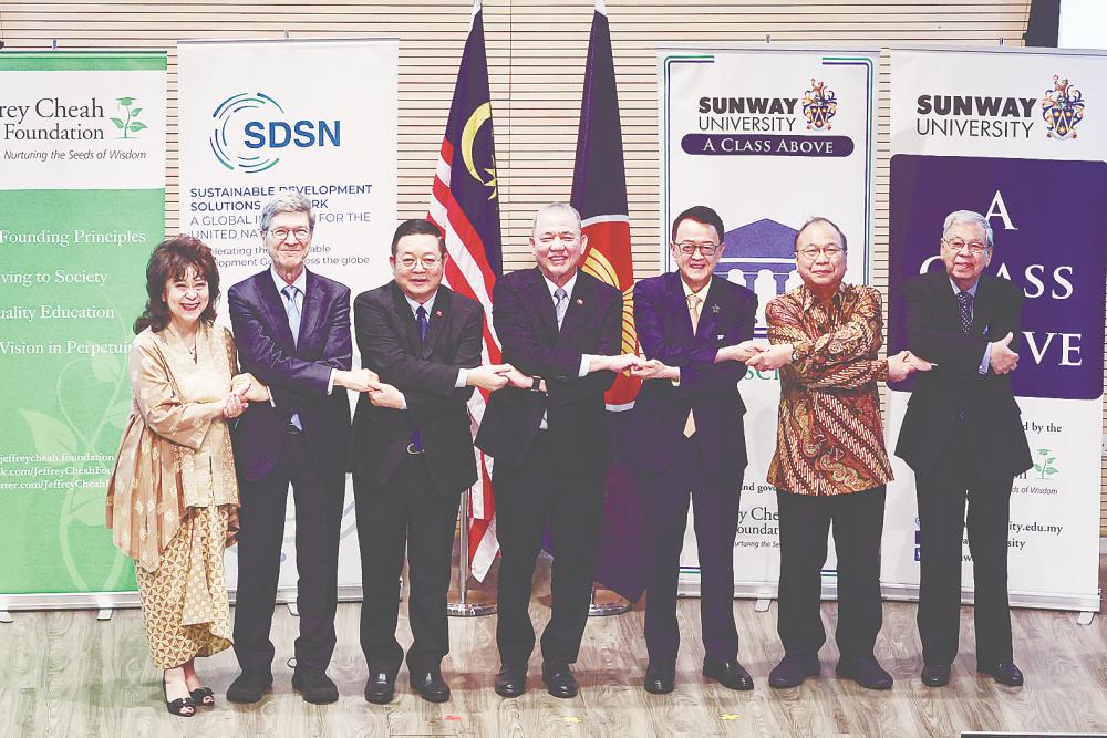 Fadillah (centre) with Asean secretary-general Dr Kao Kim Hourn (third, left) and United Nations Sustainable Development Solutions Network Malaysia chair and Sunway Group chairman Tan Sri Dr Jeffrey Cheah (third, right) leading the signature handshake at the Asean Workshop on Sustainable Development 2025 at Sunway University today. – Bernamapic