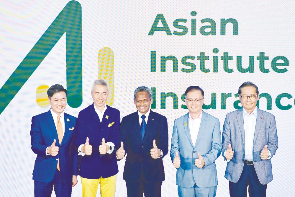 Abdul Rasheed (centre), Asian Institute of Insurance chairman Antony Lee (second from left) and CEO Paul Low (second from right) at the rebranding ceremony. – Bernamapic