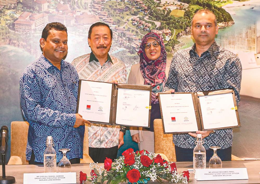 Syed Ali (left) and Arshad (right) at the loan-signing ceremony. The signing was witnessed by Tan (second from left) and Exim Bank chief business officer Nurbayu Kasim Chang.