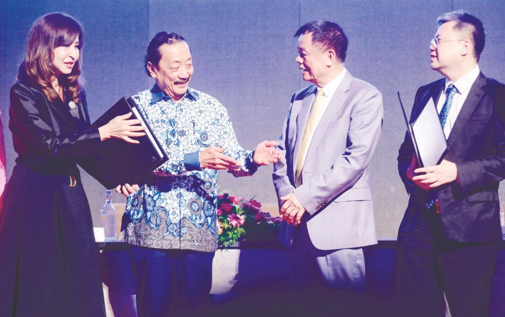 From left: Cheng, Tan, Wong and Lin during the strategic cooperation agreement signing ceremony at Berjaya Times Square Hotel. – AMIRUL SYAFIQ/theSUN