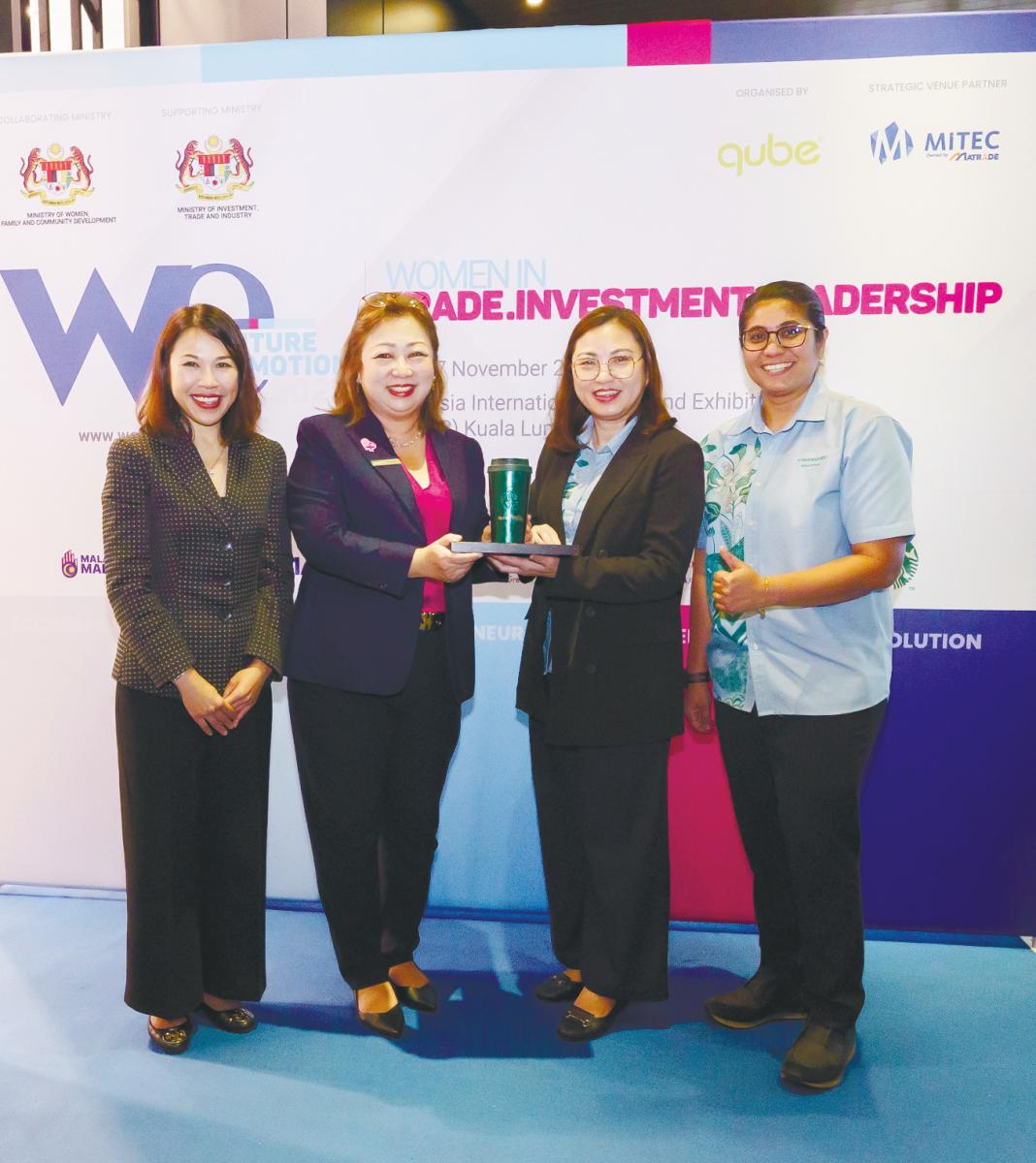 From left: Lau, Qube Integrated Malaysia managing director Jessie Tan, Berjaya Food chief financial officer Louise Chin and Berjaya Starbucks Coffee Company director of marketing and loyalty Zakiah Hanim displaying the commemorative branded tumbler with the WE2025 logo designed for the forum to be held next month.