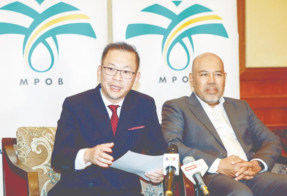 Chan (left) speaking at a press conference after the Palm Oil Economic Review and Outlook Seminar 2025 in Kuala Lumpur today. On the right is Malaysian Palm Oil Board chairman Datuk Mohamad Helmy Othman Basha. – Bernamapic