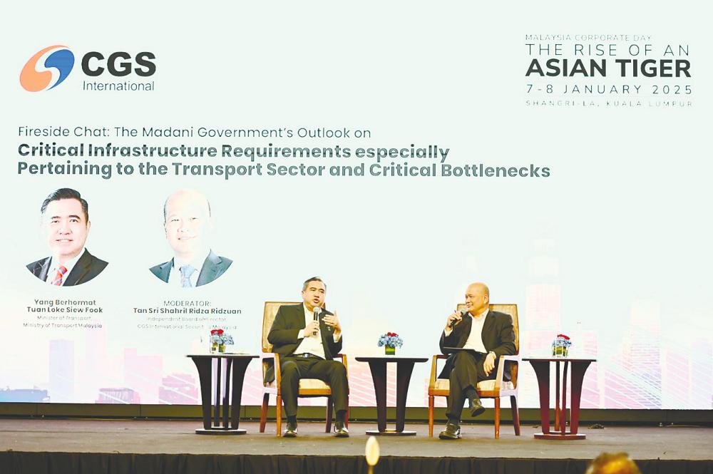 Loke speaking at the fireside chart while CGS International Securities Malaysia director Tan Sri Shahril Ridza Ridzuan looks on.