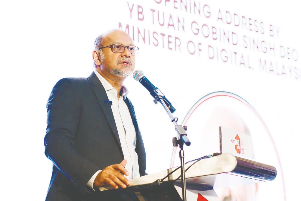 Gobind delivering his speech Nextbigtech Asia 2024. He says the nation’s growing focus on AI and data governance is important in reshaping Malaysia’s future.