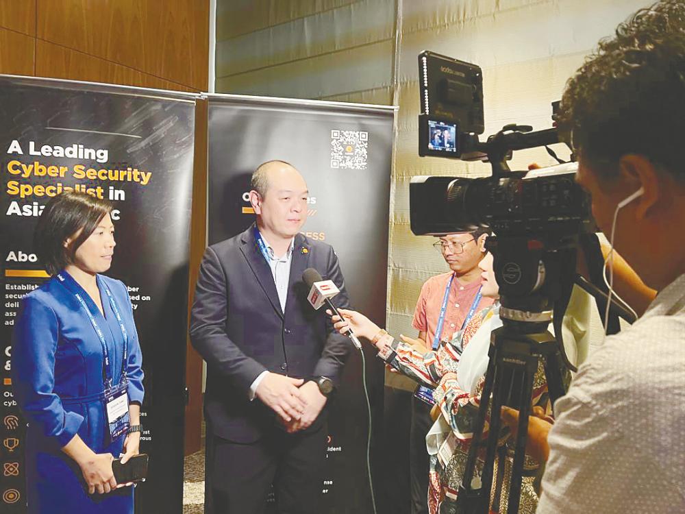 Fong (right) and Dell regional account manager (Malaysia, Singapore and Thailand) Sharon Tang speaking to reporters at the StarSentry sneak preview.