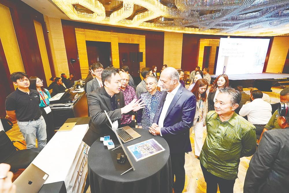 From left: MDEC head of digital industry acceleration Wan Murdani Wan Mohamad, Syed Ibrahim, Gobind and MDEC head of transformation Datuk Fadzli Abdul Wahit at the exhibition booths.