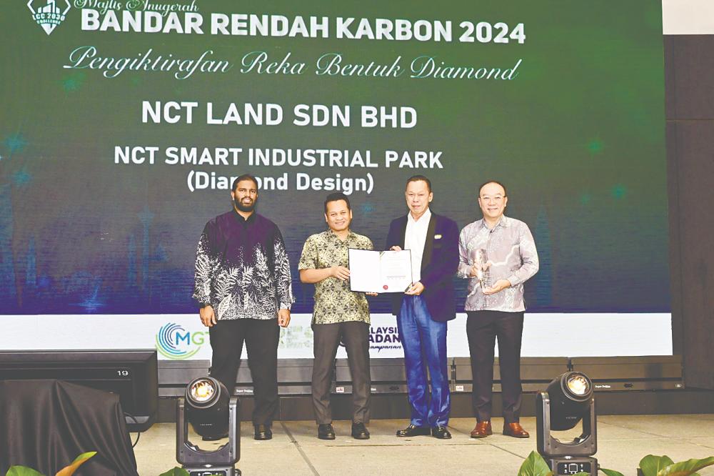 From left: Malaysian Green Technology and Climate Change Corporation acting group CEO Saiful Adib Abdul Munaff, Nik Nazmi, Yap and NCT Group chief strategist Dr Neil Foo at the award ceremony.