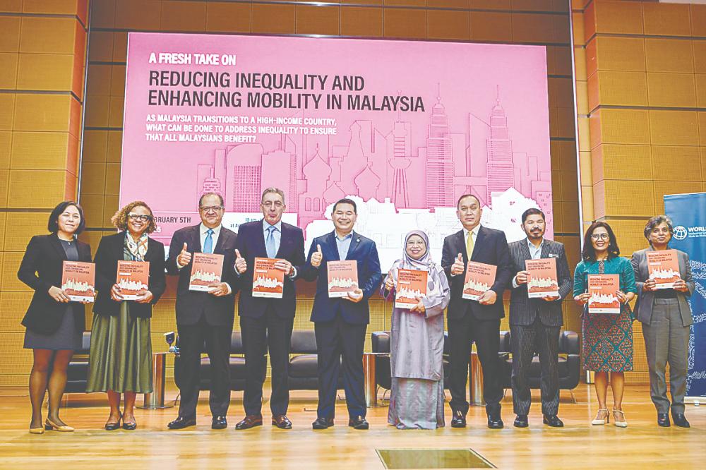 From left: World Bank senior economist Dr Laura Rodriguez, country manager for Malaysia Judith Green, poverty and equity global director Dr Luis Felipe Lopez-Calva, country director for Philippines, Malaysia &amp; Brunei Dr Zafer Mustafaoglu, Rafizi, Economy Ministry deputy secretary-general (policy) Datuk Dr Zunika Mohamed, World Bank executive director for Southeast Asia Wempi Saputra, Chief Statistician Malaysia Datuk Seri Dr Mohd Uzir Mahidin, World Bank senior economist Ririn Salwa Purnamasari and practice manager Benu Bidani at the launch of the World Bank and Ministry of Economy joint report. – Bernamapic