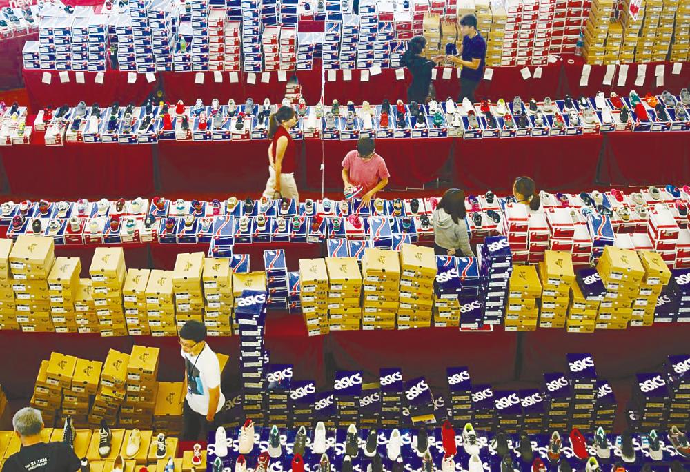 People shop for shoes at a mall in Johor Baru. – REUTERSPIX