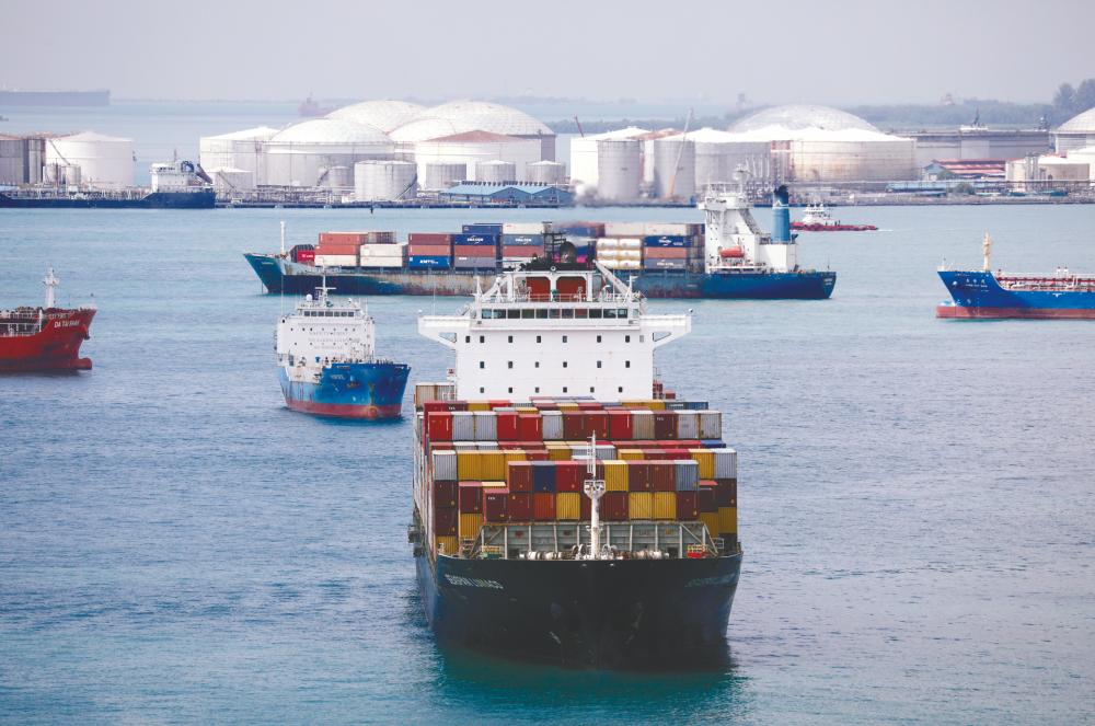 A container ship passes in the waters south of Singapore. Moody’s chief APAC economist says China’s acceleration of international trade and the rising amount of imports are being felt elsewhere in the region, with Vietnam, Singapore, Taiwan, Malaysia, and New Zealand reporting exports above those one year ago as of September. – REUTERSPIX