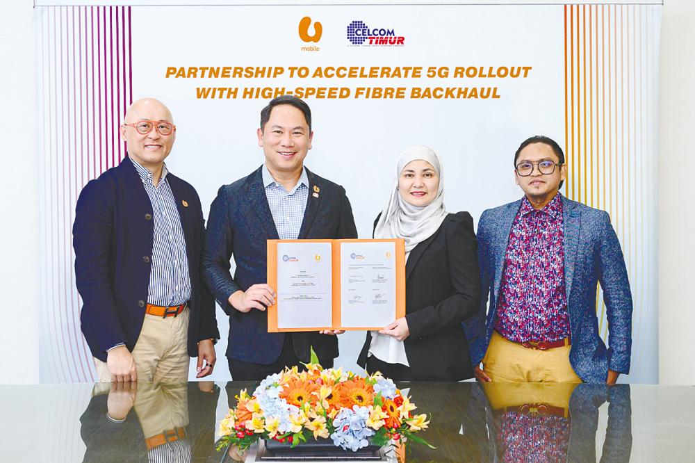 From left: U Mobile CEO Wong Heang Tuck, Woon, Zurinah and CT Sabah chief financial officer Shaharul Niza Mohamad at the signing ceremony.
