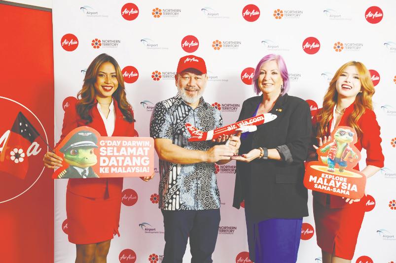 Fareh (left) and Cahill, flanked by AirAsia staff, at the launch of Kuala Lumpur-Darwin route by AirAsia Malaysia at Darwin Airport today.