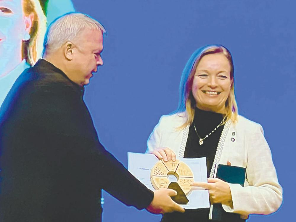 Wolff-Bye being presented with a token of appreciation at the Sustainable Action Conference 2024.