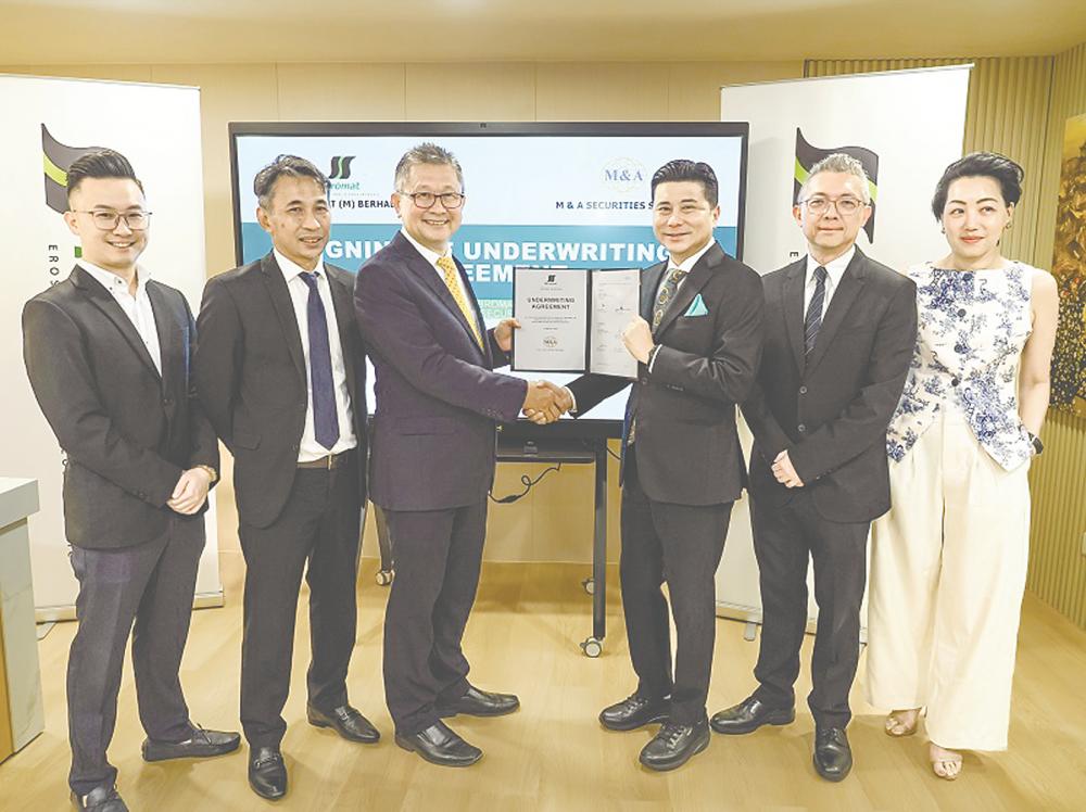 Ng (third from left) and M&amp;A Equity Holdings managing director Datuk Bill Tan, representing M&amp;A Securities, displaying the signed documents.