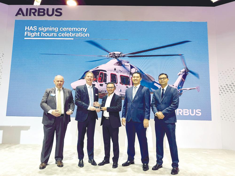 Airbus Helicopter customer support &amp; services executive vice-president Romain Trapp (second from left) with Mohd Hasery at the MoU signing ceremony, flanked by Airbus and HAS representatives.