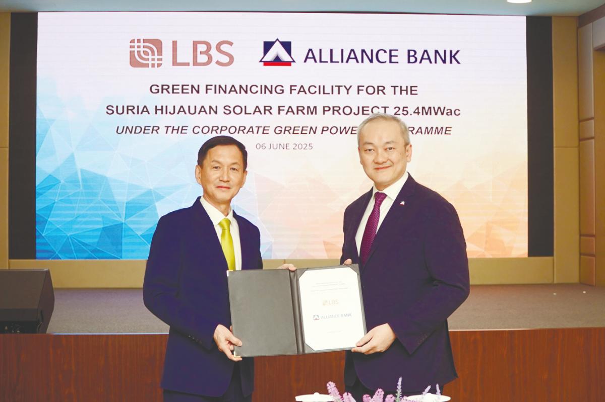 Lim (left) and Kam displaying the signed document.