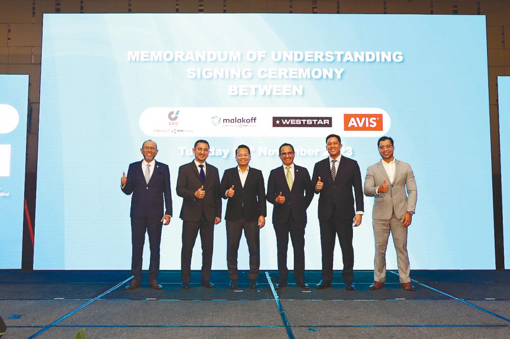 Mohd Nazersham (second from left) and Nik Nazmi (third from left) together with other officials after the signing ceremony.