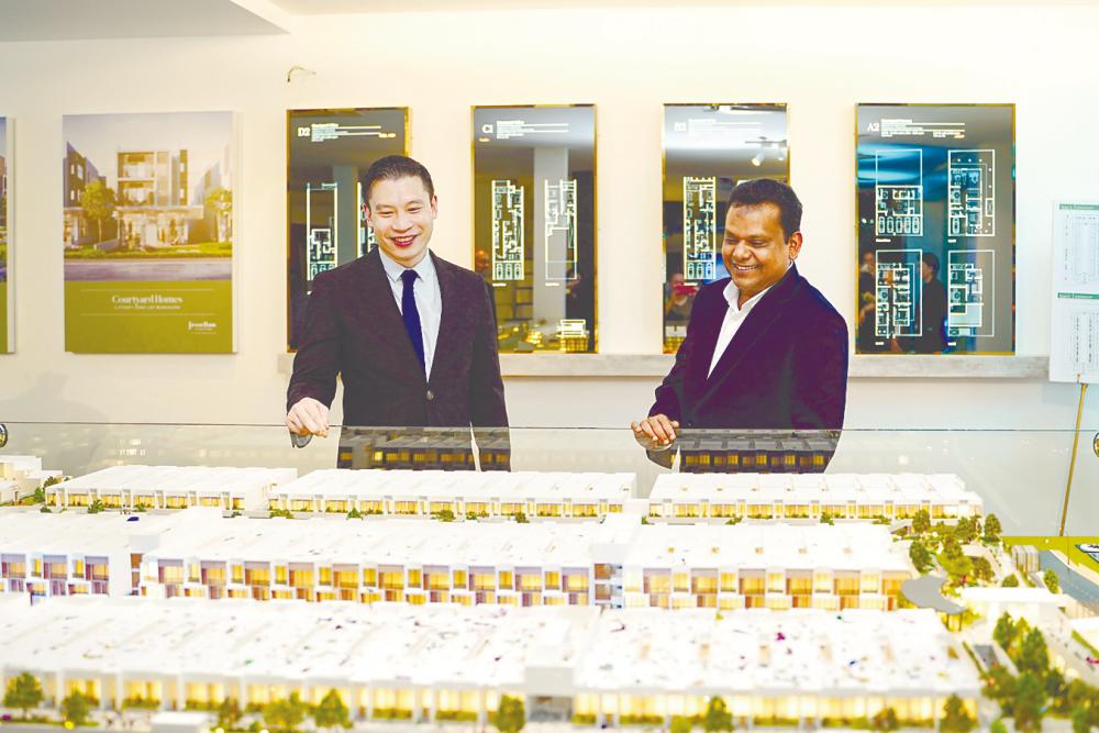 Berjaya Land executive director Tan Tee Ming (left) and Syed Ali looking at a scale model of Jesselton Courtyard at the prelaunch.