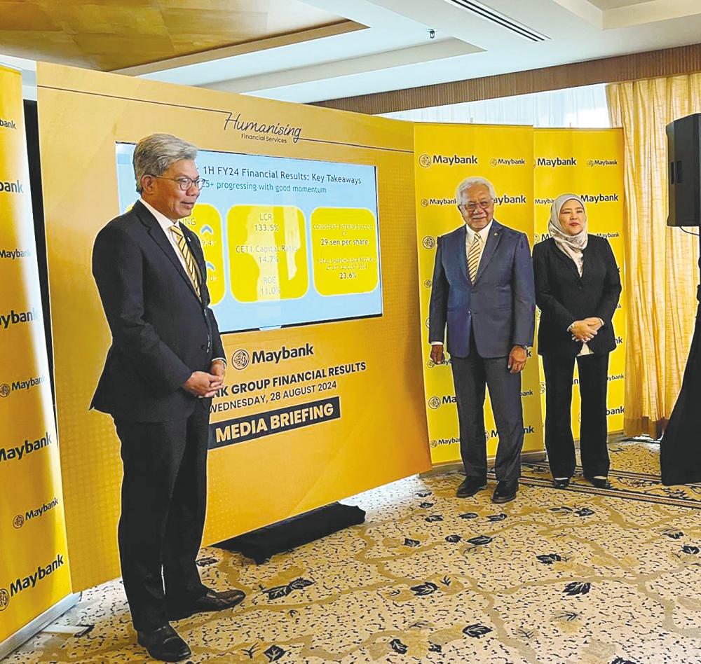 From left: Khairussaleh, Maybank chairman Tan Sri Zamzamzairani Mohd Isa and CFO Khalijah Ismail at the briefing.