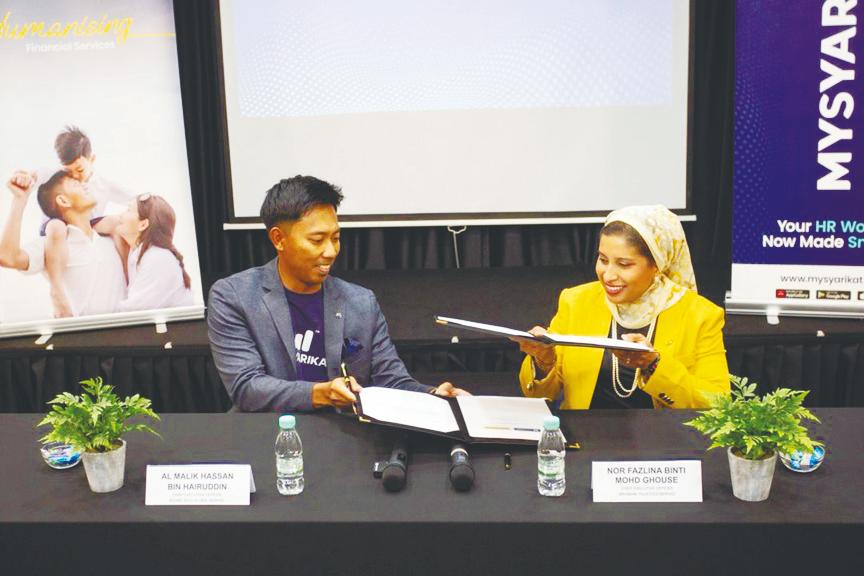 Malik and Nor Fazlina at the signing of a memorandum of understanding between Byond Tech and Maybank Trustees.